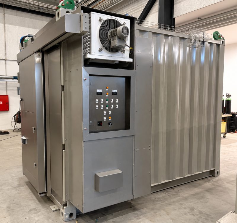 Offshore freezer container with control panel behind glass and refrigeration unit on top